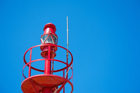 red lighthouse under a blue sky
