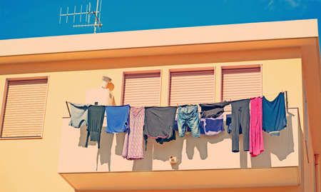 laundry line with clothes in a vintage buildingの写真素材