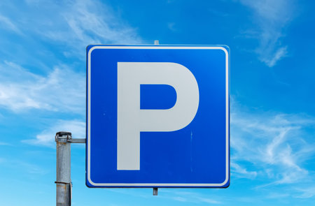 parking sign under a blue skyの写真素材