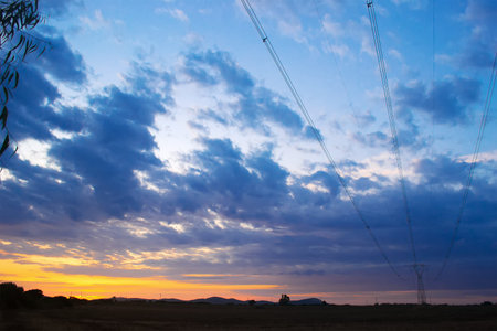 electricity pylon in the countryside at dusk
