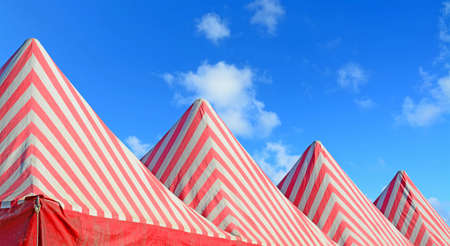 white and red tents under a blue skyの写真素材