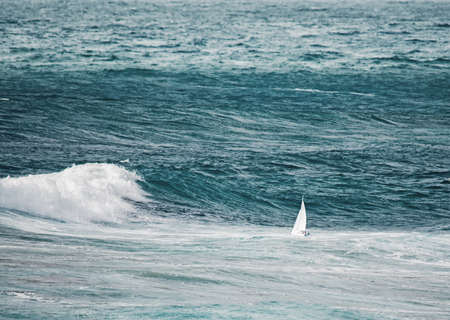 white boat sailing in the stormの写真素材