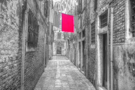 narrow street with laundry clothes in Venice, Italy. iso 100, heavy processed for hdr tone mapping and selective desaturation effects.の写真素材