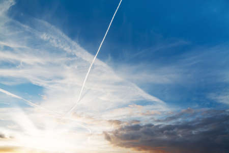 colorful sunset with white and dark cloudsの写真素材