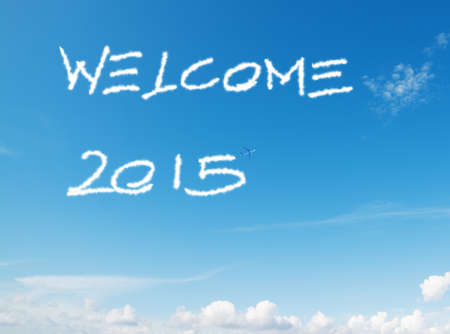 "welcome 2015" written in the sky with contrails left by airplaneの写真素材