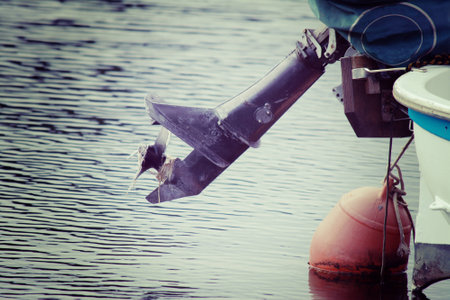 old outboard engine in Temo river, Sardinia. Processed for vintage tone effect.の写真素材