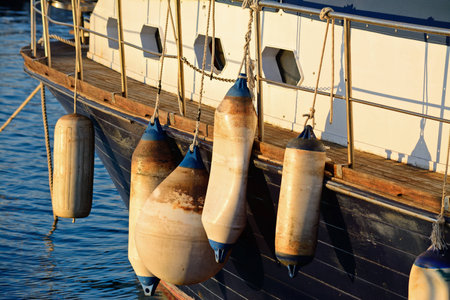 several fender on a wooden boat at sunsetの写真素材