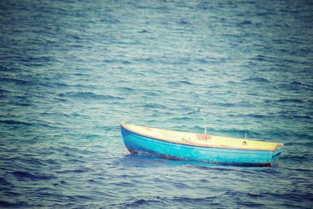 old boat in the sea. Processed for vintage tone effect.の写真素材