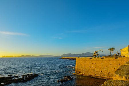Alghero bastion on a clear day at sunset.