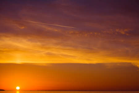 sun over the sea at sunset.の写真素材