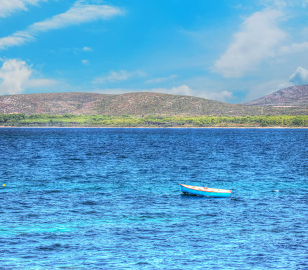 wooden fishing boat alone in the sea. Shot in Porto Conte, Italy.の写真素材