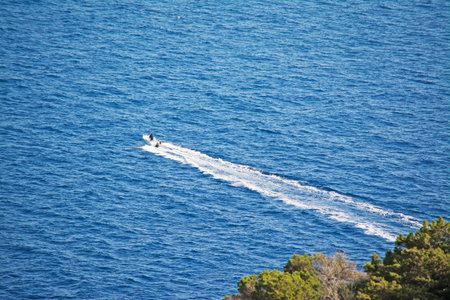white motorboat sailing in the blue sea. 