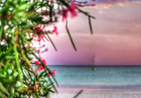 boat alone in the sea at dawn. Shot in Sardinia, Italyの写真素材