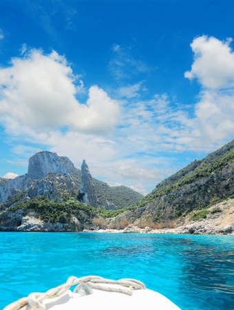 reaching Cala Goloritze on a white boat under clouds. Shot in Sardinia, Italyの写真素材