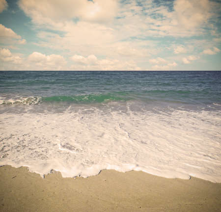 golden shore under a cloudy sky in vintage tone. Shot in Sardinia, Italyの写真素材