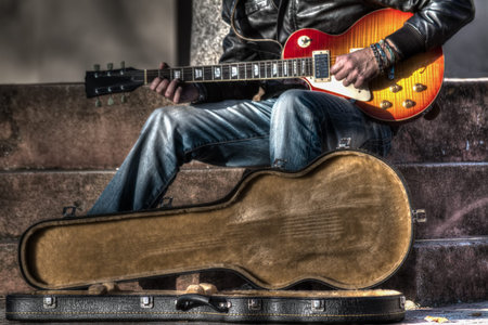 guitar player with an open guitar case in hdr