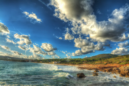 scenic clouds over Le Bombarde beach in Alghero, Italyの写真素材
