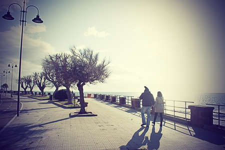 couple walking by the sea in vintage effectの写真素材