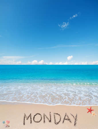 monday written on a tropical beach under cloudsの写真素材