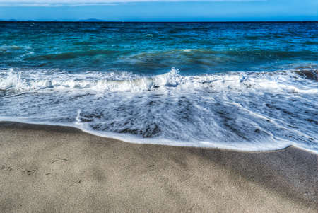 small waves by the shore in Platamona in hdr tone mapping effectの写真素材