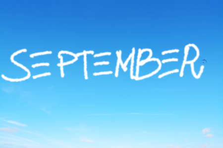 september written in the sky with contrailsの写真素材