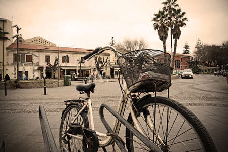 old bicycle parked in an Italian square in vintage toneの写真素材