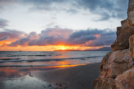 rocks and sand in Alghero shore at sunset. Shot in Sardinia, Italy