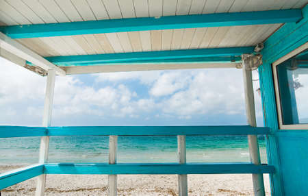 white and turquoise wooden terrace by the shore. Shot in Sardinia, Italyの写真素材