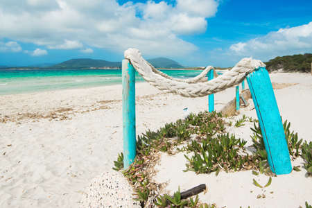 close up od a white rope on  turquoise wooden poles by the seaの写真素材