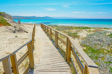 wooden boardwalk to the beach in Capo Testa, Sardiniaの写真素材