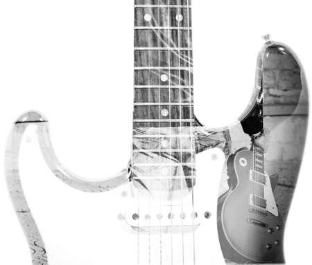 back view of a man holding a guitar and guitar silhouette in double exposure in black and whiteの写真素材