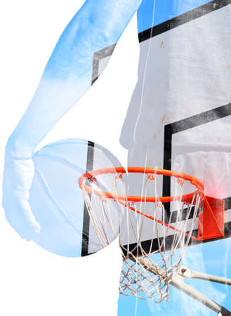 backview of a basketball player holding the ball and hoop in double exposure effectの写真素材
