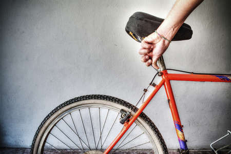 man repairing a mountain bike in a workshop. Processed for hdr tone mapping effectの写真素材