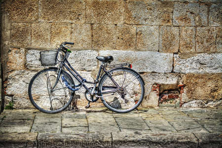 bicycle against a rustic wall in Tuscany, Italyの写真素材