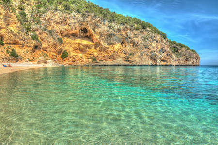 Cala Biriola on a clear day in hdr tone mapping effectの写真素材