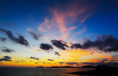 colorful sky over Capo Caccia at dusk, Sardiniaの写真素材