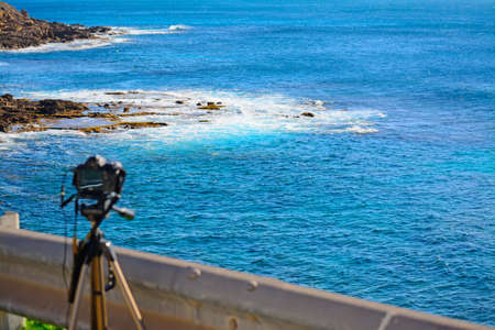 dslr camera on tripod by the sea in Alghero, Sardiniaの写真素材