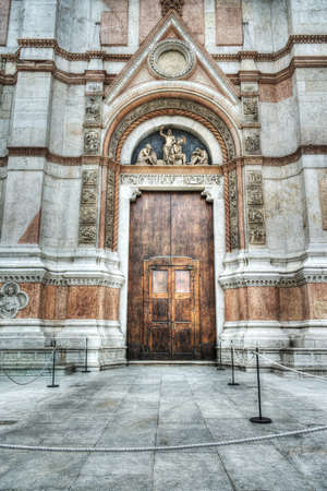 wooden door in San Petronio cathedral in Bologna, Italyの写真素材