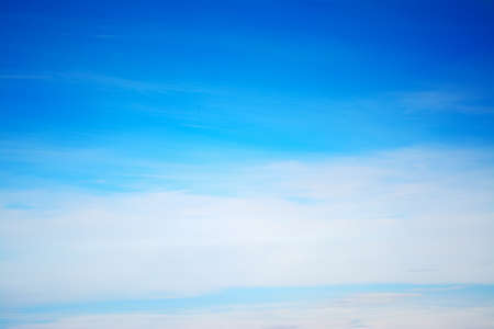 blue sky with white, soft cloudsの写真素材