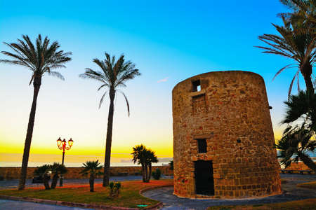 antique sighting tower by the sea in Alghero, Sardiniaの写真素材