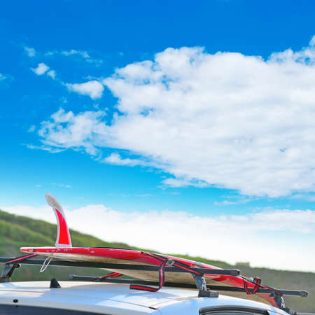 detail of surfboard fin under a cloudy skyの写真素材
