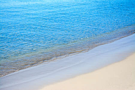 blue and golden shore in Alghero, Sardiniaの写真素材