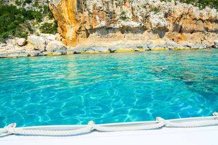 white boat by the shore in Orosei Gulf, Sardiniaの写真素材