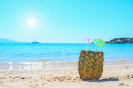 cool drink by the shore with a boat in the backgroundの写真素材