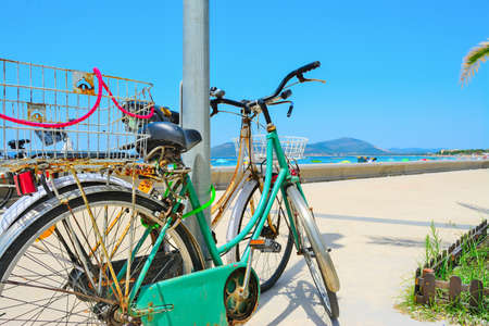 old bikes by the sea in Alghero, Italyの写真素材