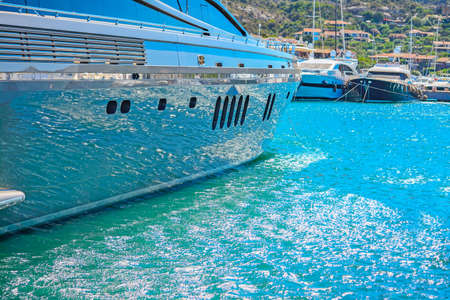 water reflected on a yacht hull in Porto Cervo harbor, Sardiniaの写真素材