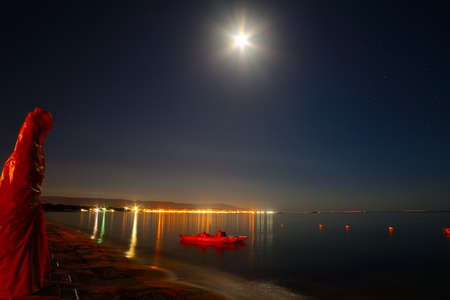 parasol and boat on a starry night in Alghero, Sardiniaの写真素材