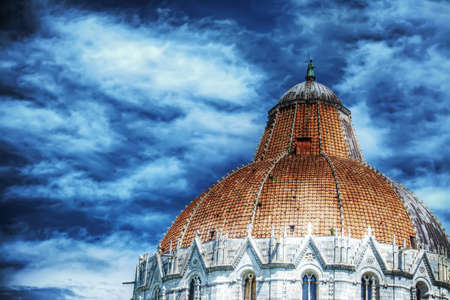 Duomo dome in Pisa under a cloudy sky, Italyの写真素材