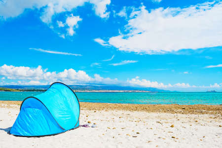 blue tent by the sea in Alghero, Sardiniaの写真素材