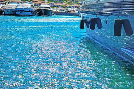 harbor water reflected in a yacht hull in Porto Cervo, Italyの写真素材